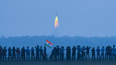 Group of people watching a rocket launch in India