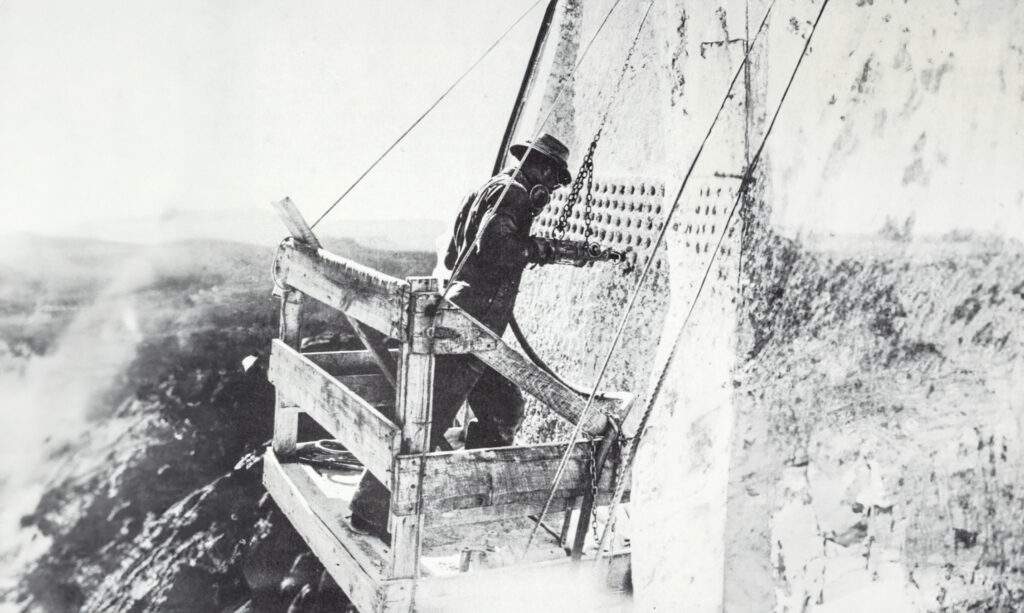 Worker using a jackhammer on Mount Rushmore