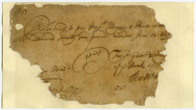 An old torn piece of paper showing money owed to a customer from the 17th century